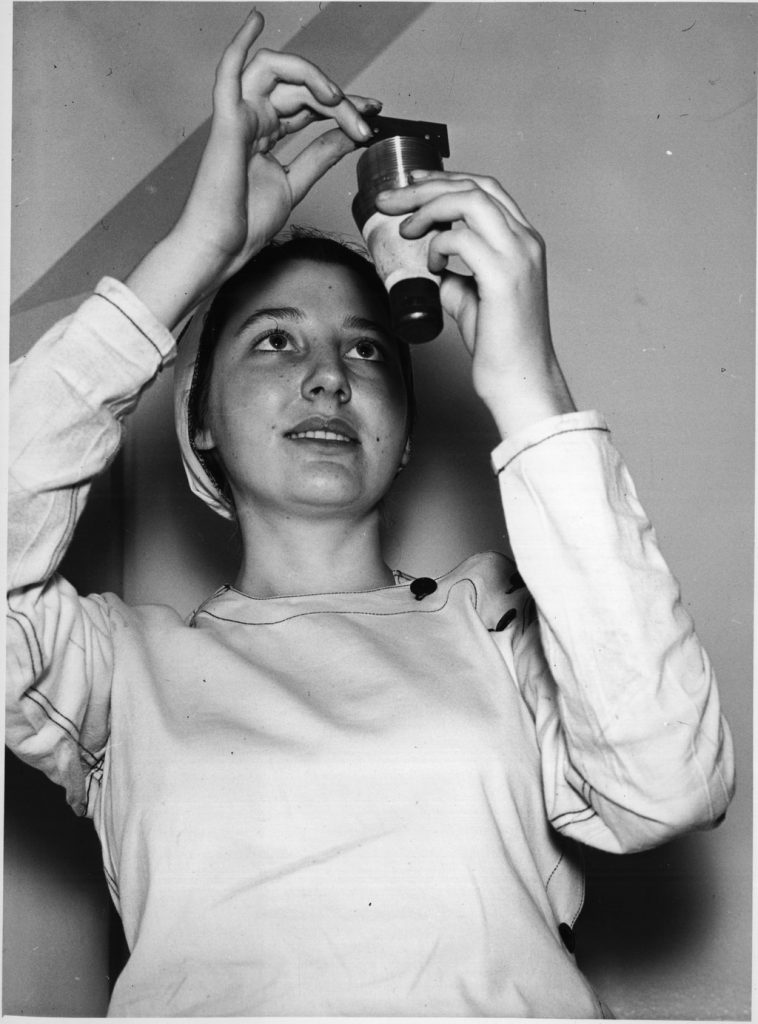 A woman measuring piece of munitions at the General Engineering Company 1940s vintage photo from Archives of Ontario