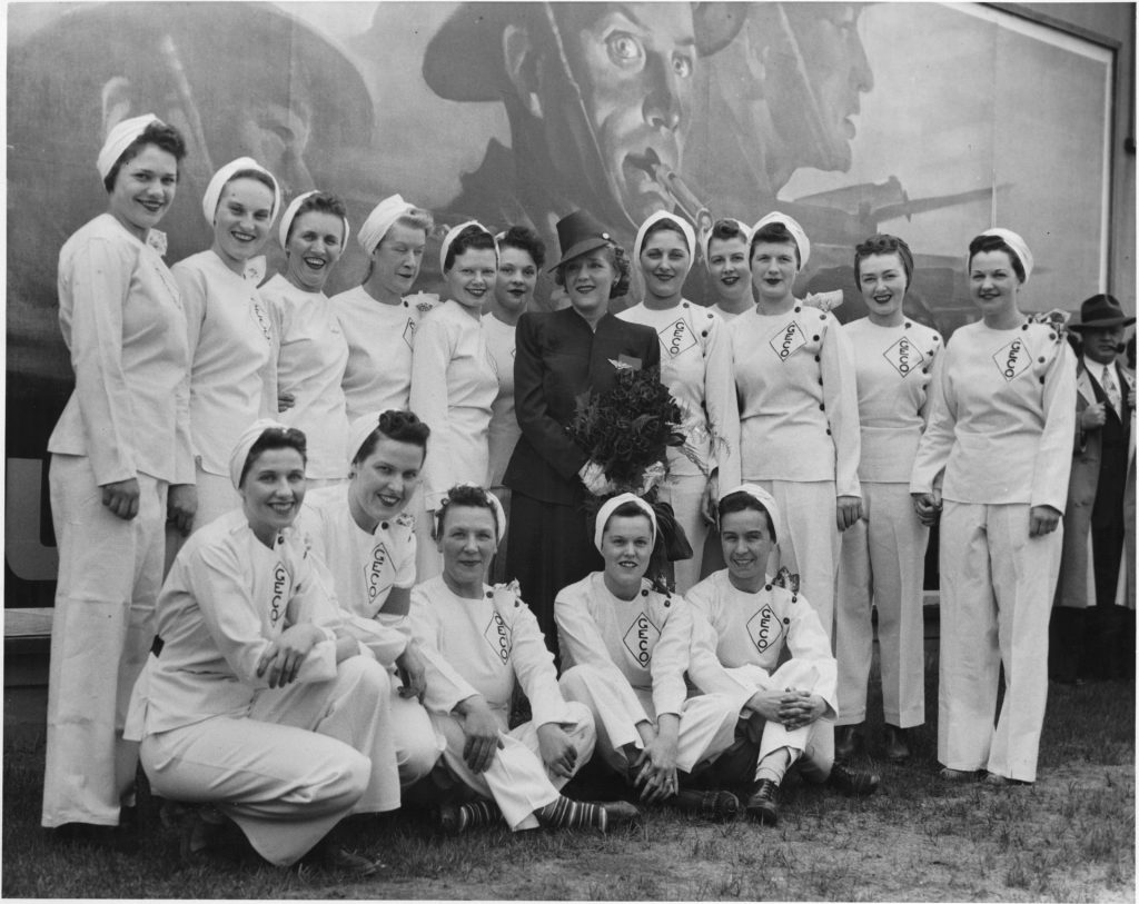 Mary Pickford posing with a group of employees during her visit to the General Engineering Company 1940s vintage photo