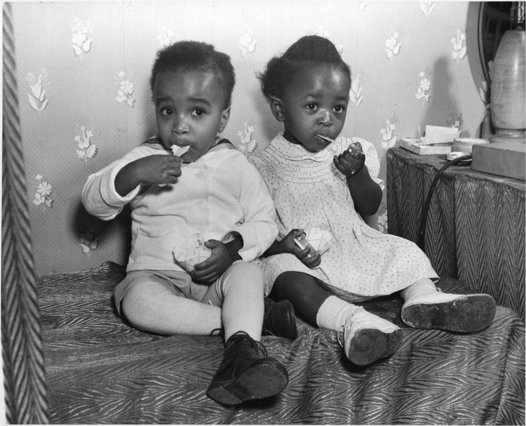 Two Black children at a war time nursery at the General Engineering Company (Canada) munitions factory-1940s vintage photo