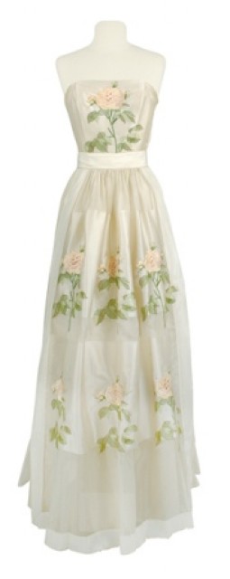 Carrie Munn Apron Gown 1940s vintage dress. The dress is ivory organza jacquard with the sleeveless boned bodice embroidered with a single large variegated pastel pink rose on a stalk. The circle skirt has two underlayers and the long apron with picot trim and two rows embroidered roses.