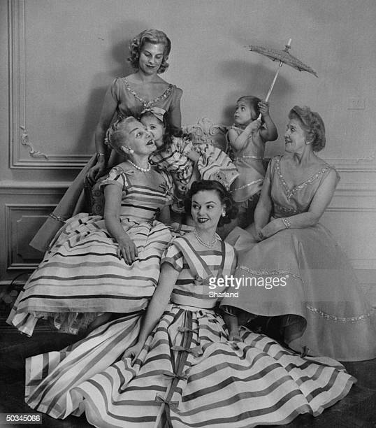 1950s Vintage Photo: Mrs. Orson Munn (seated L) and Mrs. Bruno Graf (seated R) posing in a fashion show with their grand daughters, daughter and daughter-in-law. All the women are wearing 1950s dresses