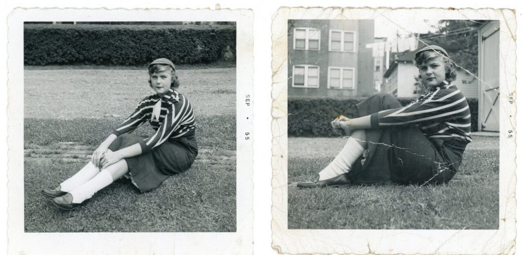 1950s photo of a young girl, young teenager in 1950s fashions sitting on the lawn outside. 