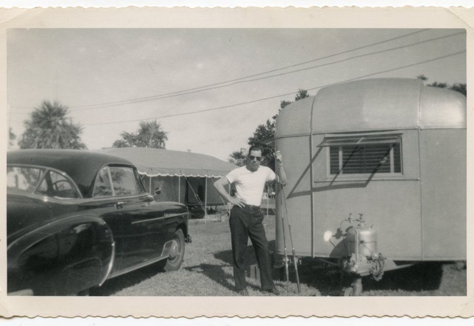 Vintage 1940's photo of vintage trailer and car and man with fishing poles