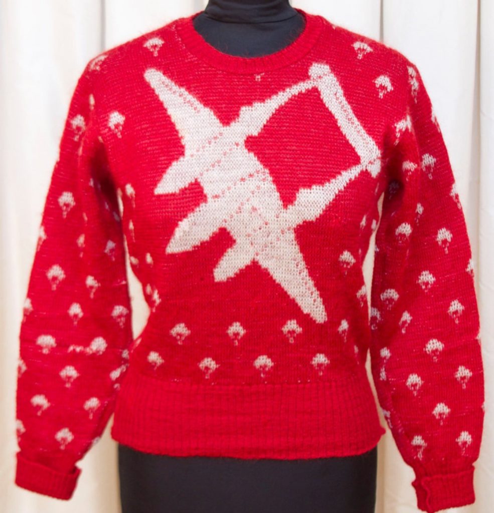 1940s Fashion: 1940s Jantzen sweater. The airplane sweater features an amazing P-38 Lightning WWII Fighter Jet