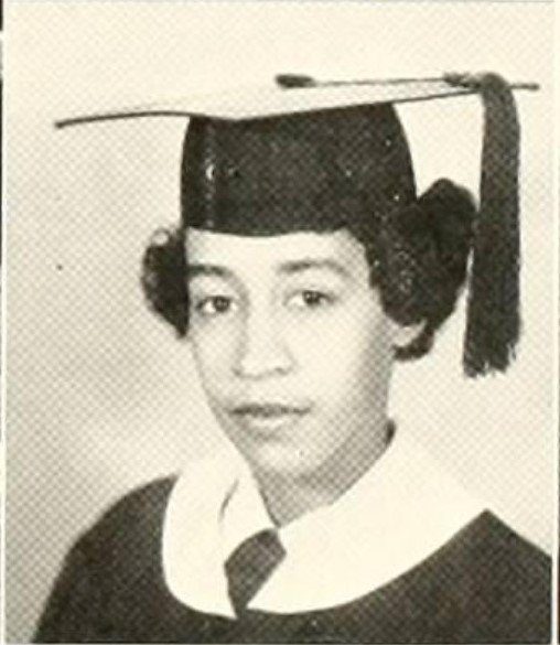 1950s vintage yearbook photo of a young Black Woman graduating from college. 