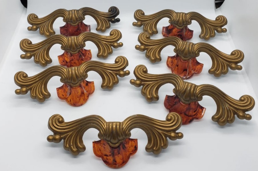 Set of 7 1920s metal drawer pulls with bakelite amber inset