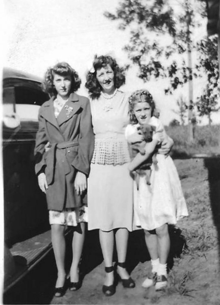 1940s Vintage Photo of a mother and her 2 daughters in 1940s Hairstyles and 1940s fashions. Helo Flamingo brooch! 