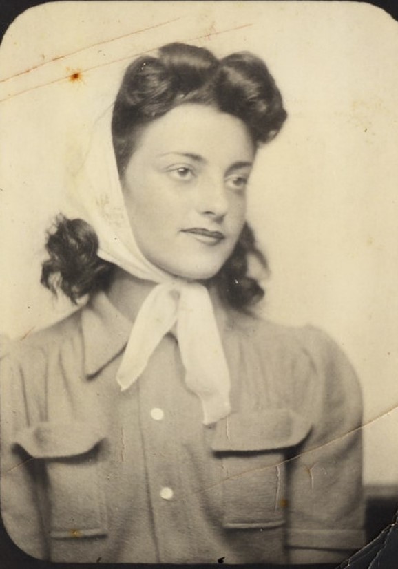 1940s vintage photo of a young pretty  woman in a photobooth wearing a hairscarf on her 1940s hairstyle