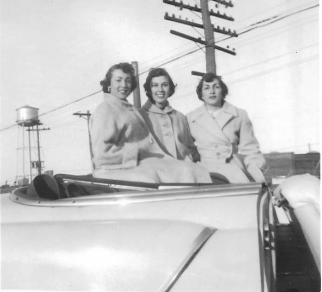 1950s vintage photo of 3 women sitting in car with 1950s coats on. Black and White Photo