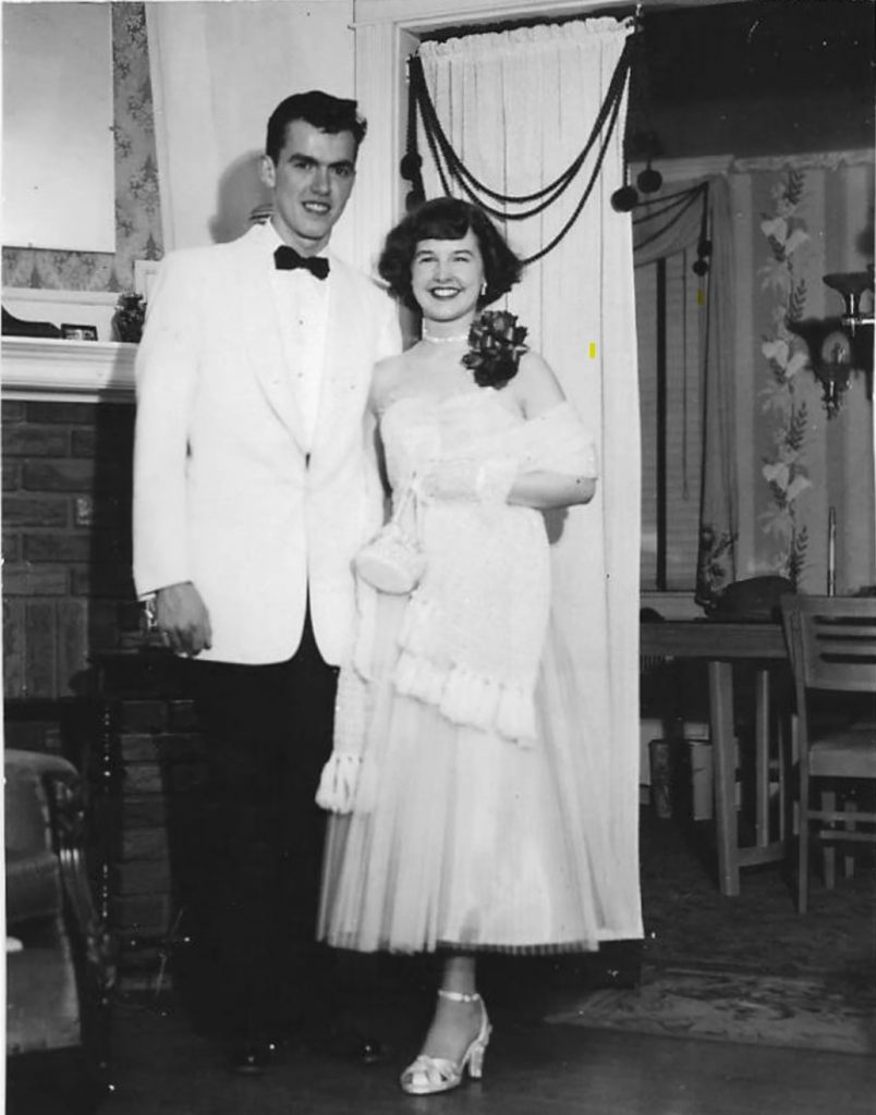 1950s Vintage Photo of a very stylish young man and woman posing for a photo before they head off to the prom. LOVE her prom dress and her shawl! And purse and corsage and shoes..Love it all! 