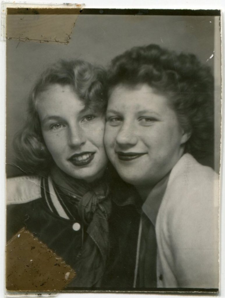 late 1940s early 1950s vintage photo booth image of two young women posing together