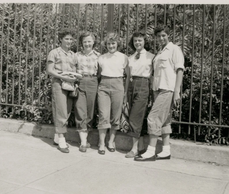 1940s vintage photo of a group of young women in rolled up jeans and bobby sox and late 1940s hairstyles vintage teens