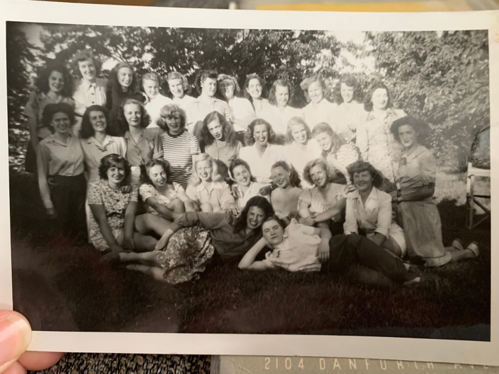 1940s vintage photo of a group of women in 1940s summer fashions posing for a group photo