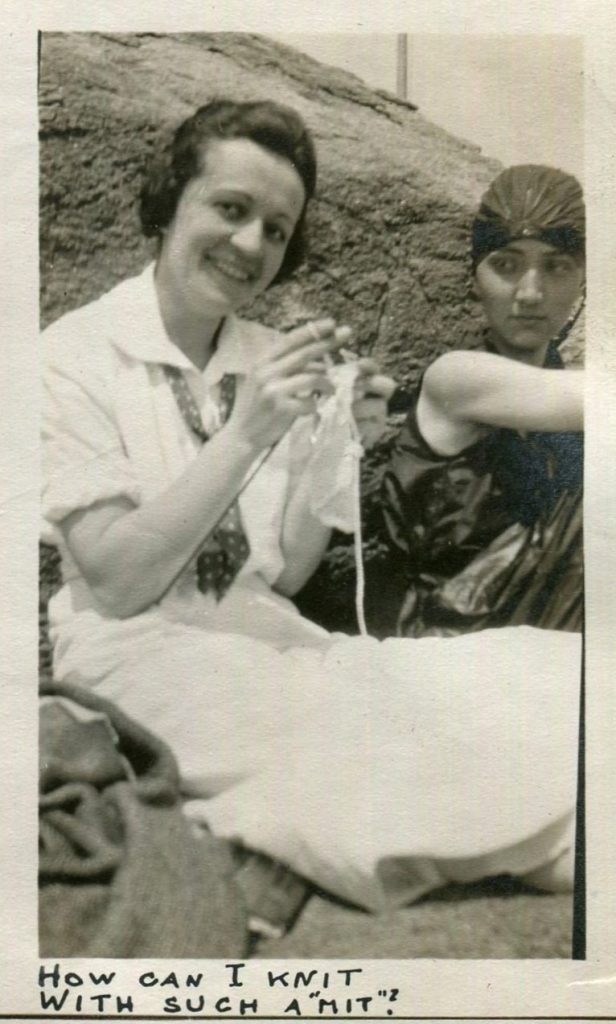  "How can I knit with such a "mit"? Ha Ha! 1920s vintage photo of two women at a picnic at the lake. The one woman is wearing a swim cap and swimsuit