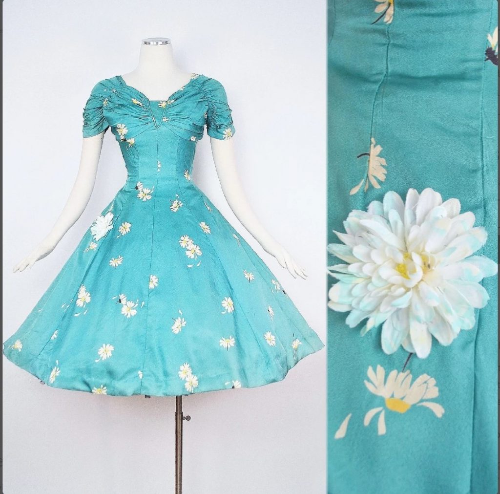 Vintage 1950s Sundress by Iconic Designer "Suzy Perette".Constructed in a Beautiful Shade of Mint Green Silky Satin Fabric with Floral White & Yellow Daisy Prints and a Full Circle Swing Skirt.