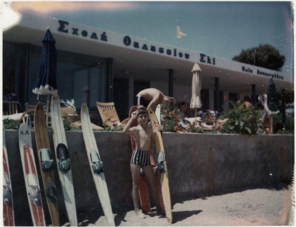 Summer in Greece. 1950s / Early 1960s Polorid photo of a young boy in Greece at a beach resort posing with waterskiis. 