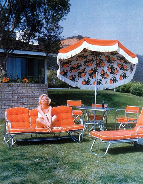 Vintage Photo of Marilyn with her bright orange patio set. Love that rose fabric detail on the umbrella!