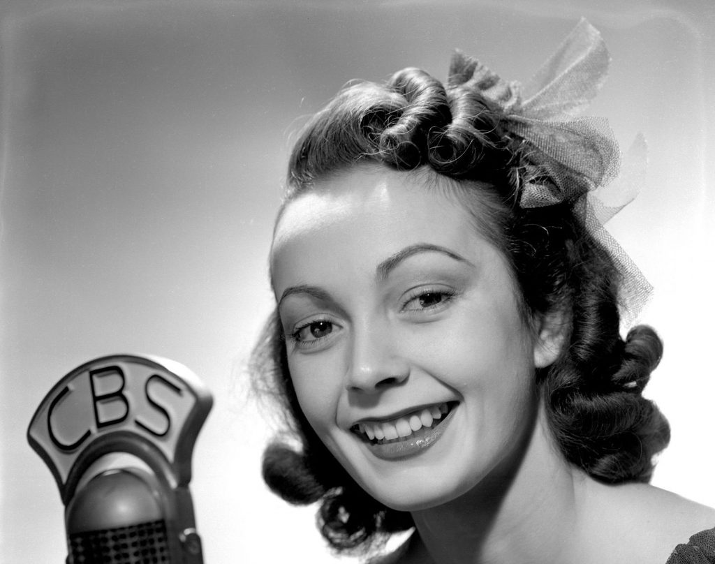 1940s vintage photo of Big Band singer Paula Kelly wearing a 1940s hairstyle. 