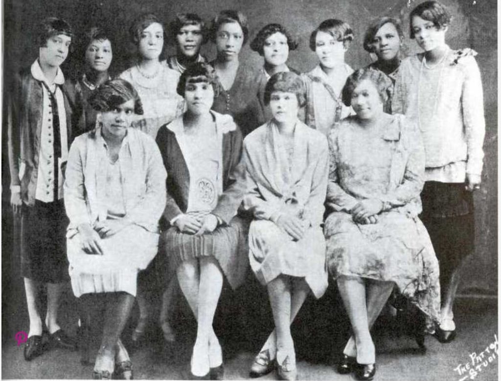 1920s vintage photo of the Black Sorority SIGMA GAMMA RHO, ALPHA CHAPTER, 1924. The Black Women are all wearing 1920s fashions.