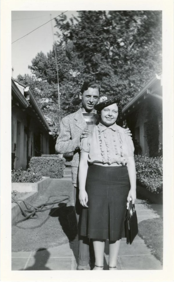 1930s vintage photo of a man and woman in 1930s fashions from 1939 posing together in a garden