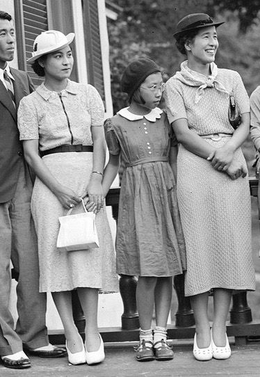 1930s vintage photo of Asian women and a young girl and one man in 1930s fashions. 