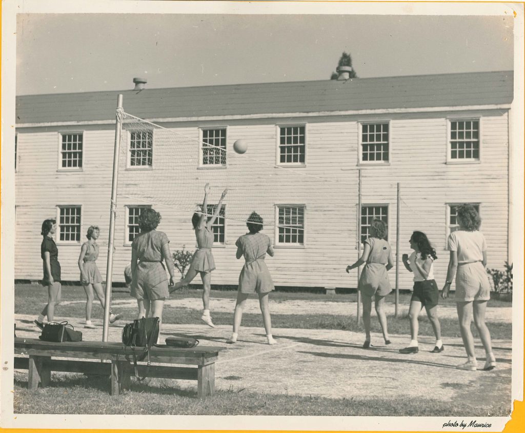 1940s 1950s vintage photo of women college students playing volleyball in their gym uniforms at Palm Beach Junior College