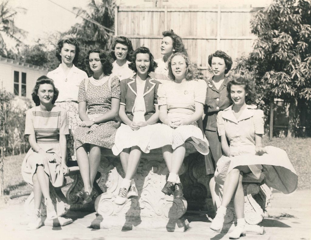 1940s vintage image of young women college students in 1940s fashions including saddle shoes posing together with their 1940s hairstyles