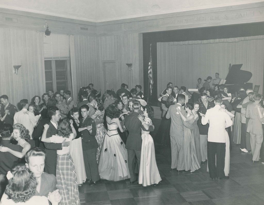 1940s vintage photo of the Palm Beach Junior College ball featuring 1940s evening dresses, men in uniform and 1940s hairstyles.