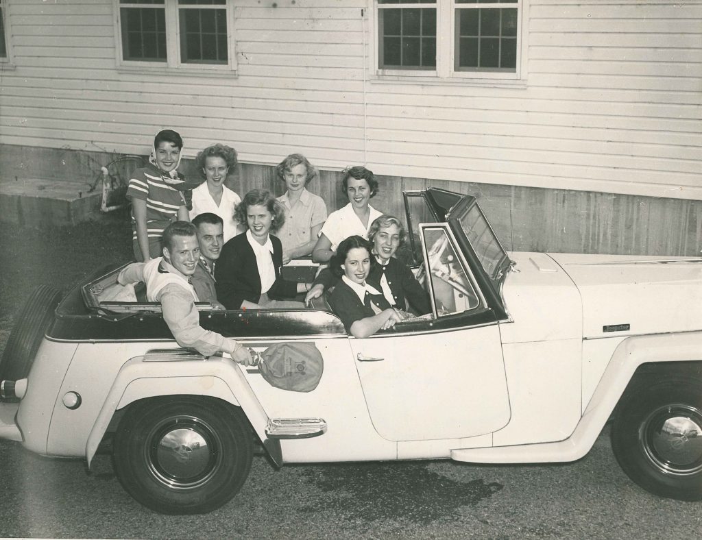 1950s vintage photo of college students in a jeepster in 1950s fashions from 1951