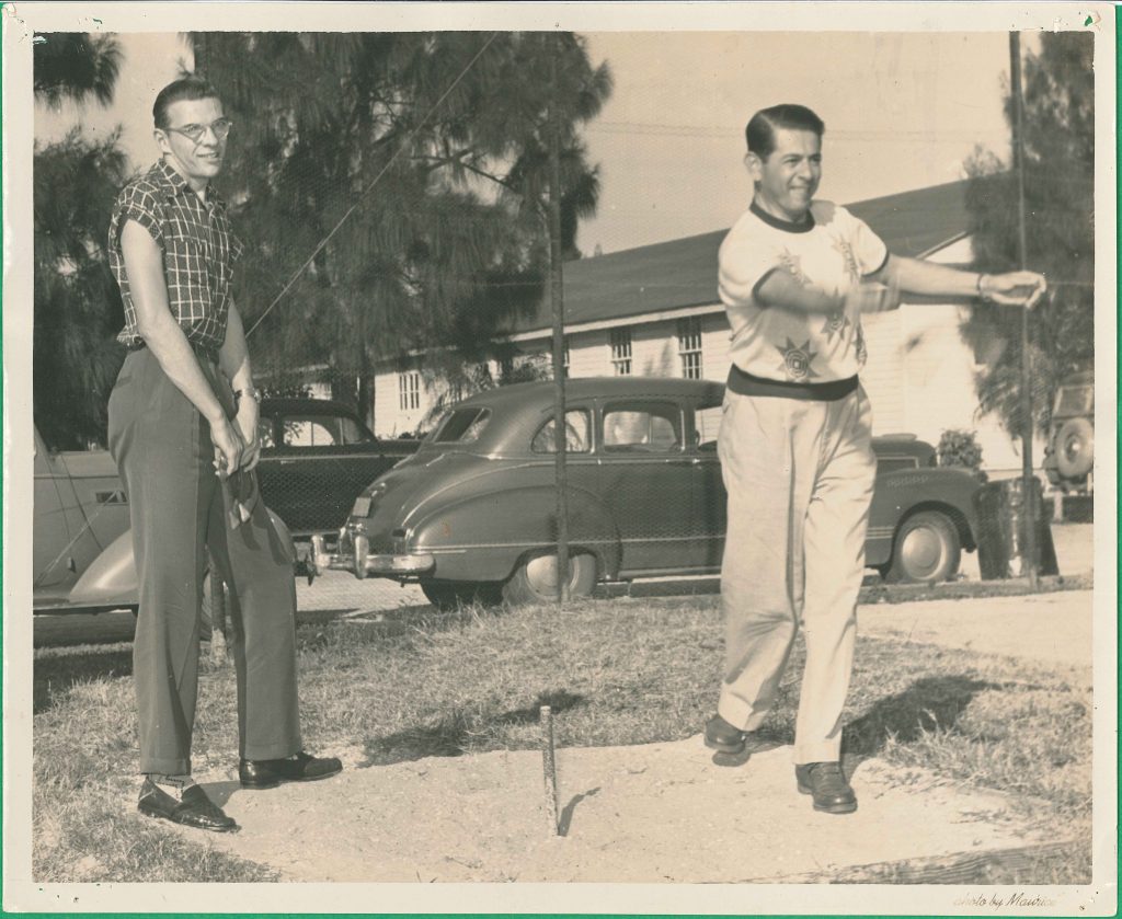 1950s vintage photo of two young men in college playing horseshoes at palm beach college in early 1950s fashions