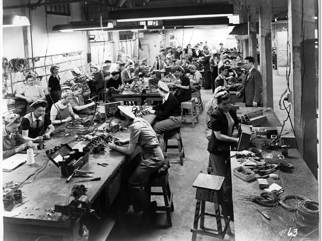 1940s vintage photo of Canaidan Women soldering and assembling cables for airplanes, at the 
Canadian Car and Foundry Co., 1945 for the Canadian Home Front Effort. 