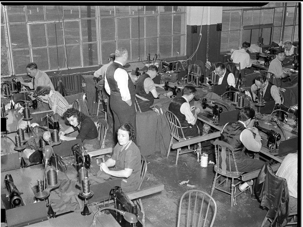 1940s photo of Women and Men in the sewing room at Tip Top Tailor making uniforms for Canadian soldiers.