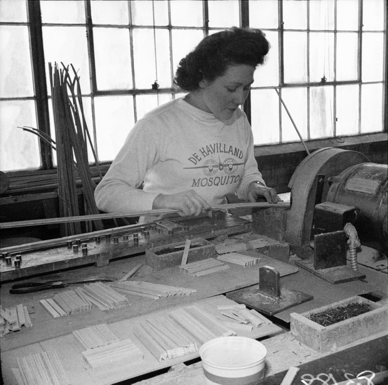 1940s vintage photo, June 21, 1943. Bernice Coulter soldering airplane parts, DeHavilland factory. Women on the WW2 Home Front. 