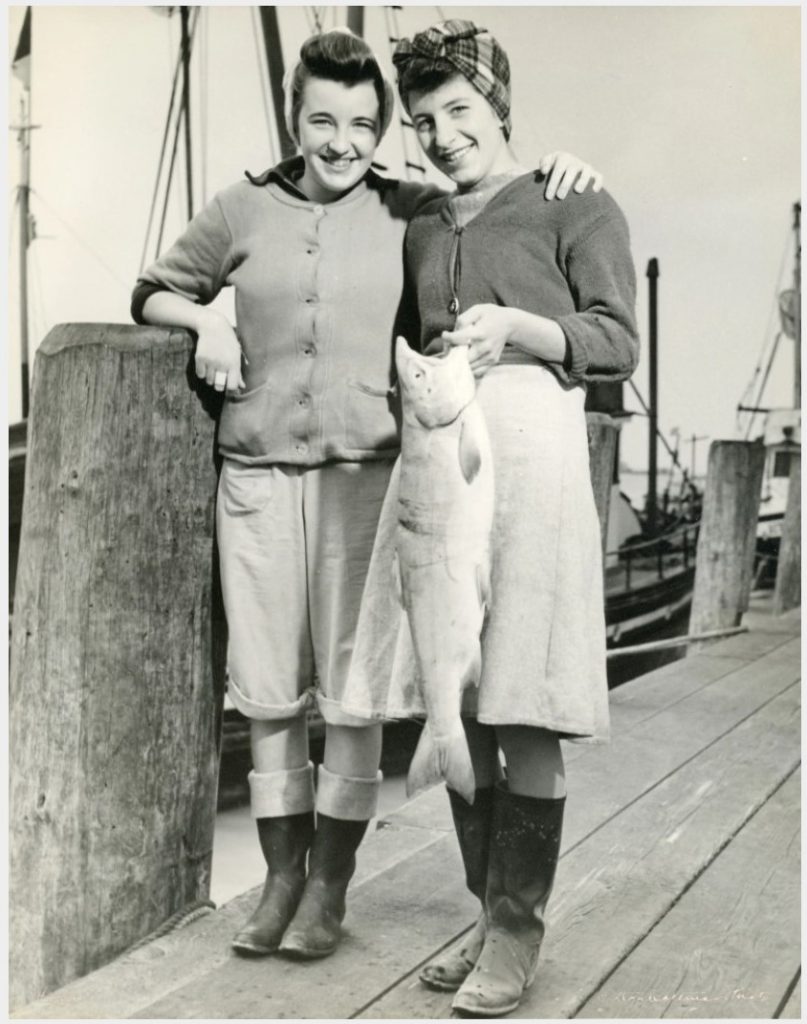 1940s vintage photo of women working in salmon canneries in BC, Canada during WW2. Working for the Home Front effort. 