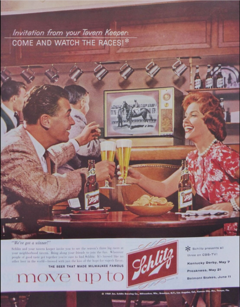 1960S vintage ad for Schlitz Beer featuring a couple in 1950s fashions sitting in a Bar / Tavern enjoying a beer while watching the horse races. 