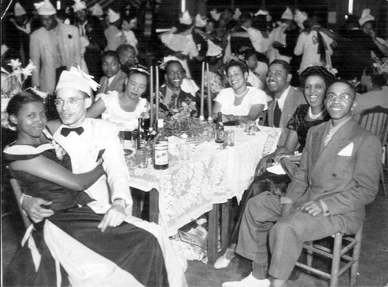 1940s vintage photo of a group of Black men and women celebrating New Years eve at the El Dorado Ballroom, Houston, Texas