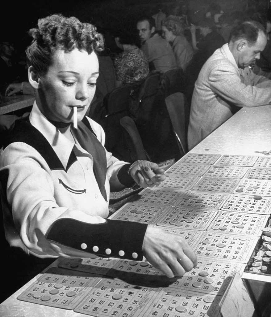 1940s vintage image of a woman in westernwear and a 1940s hairstyle Playing bingo at Golden Nugget, February 1947 - Photo by Jon Brenneis