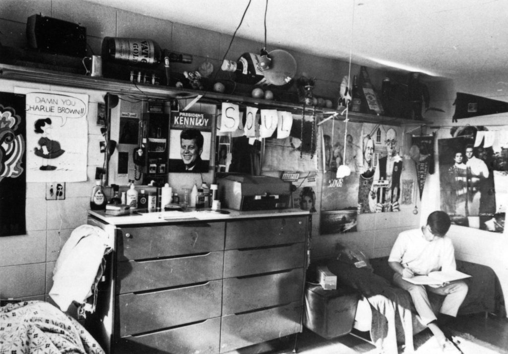 1960s vintage photo of a Student dorm with posts of JFK, Peanuts, and Simon & Garfunkel at the University of Wisconsin-Madison