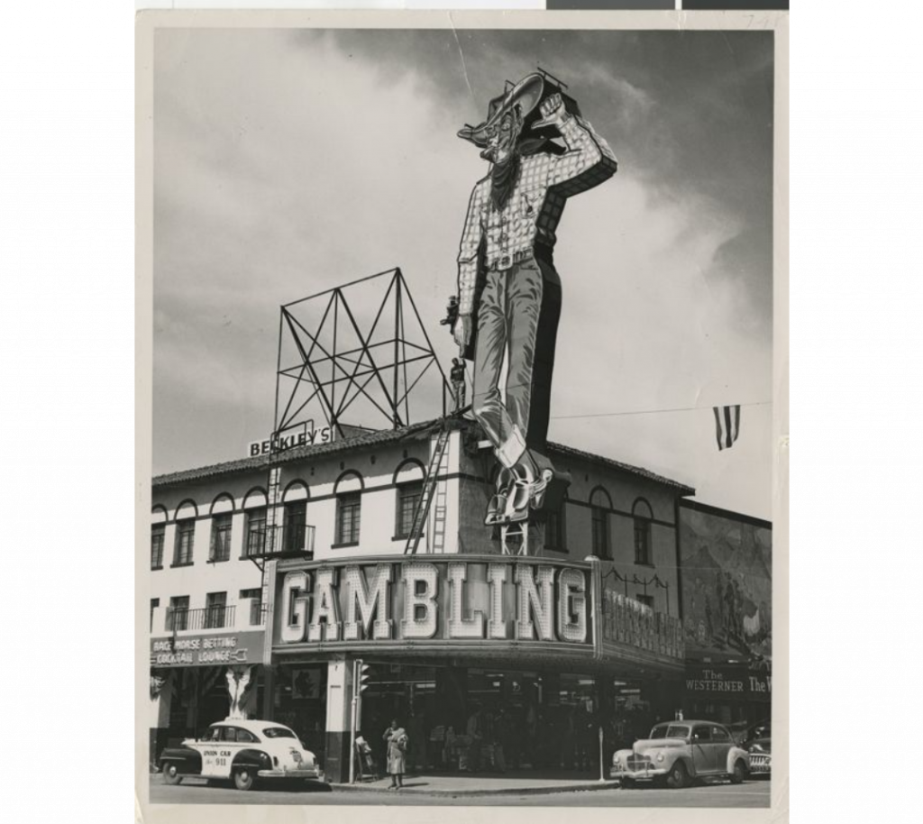 1950s vintage Photograph of YESCO workers installing Vegas Vic at the Pioneer Club (Las Vegas), 1951