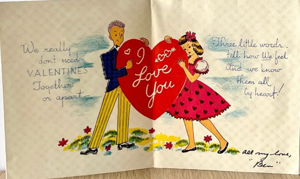 1950s Vintage Valentine Day card featuring an illustration of a young couple in 1950s fashions holding a heart that say I love you