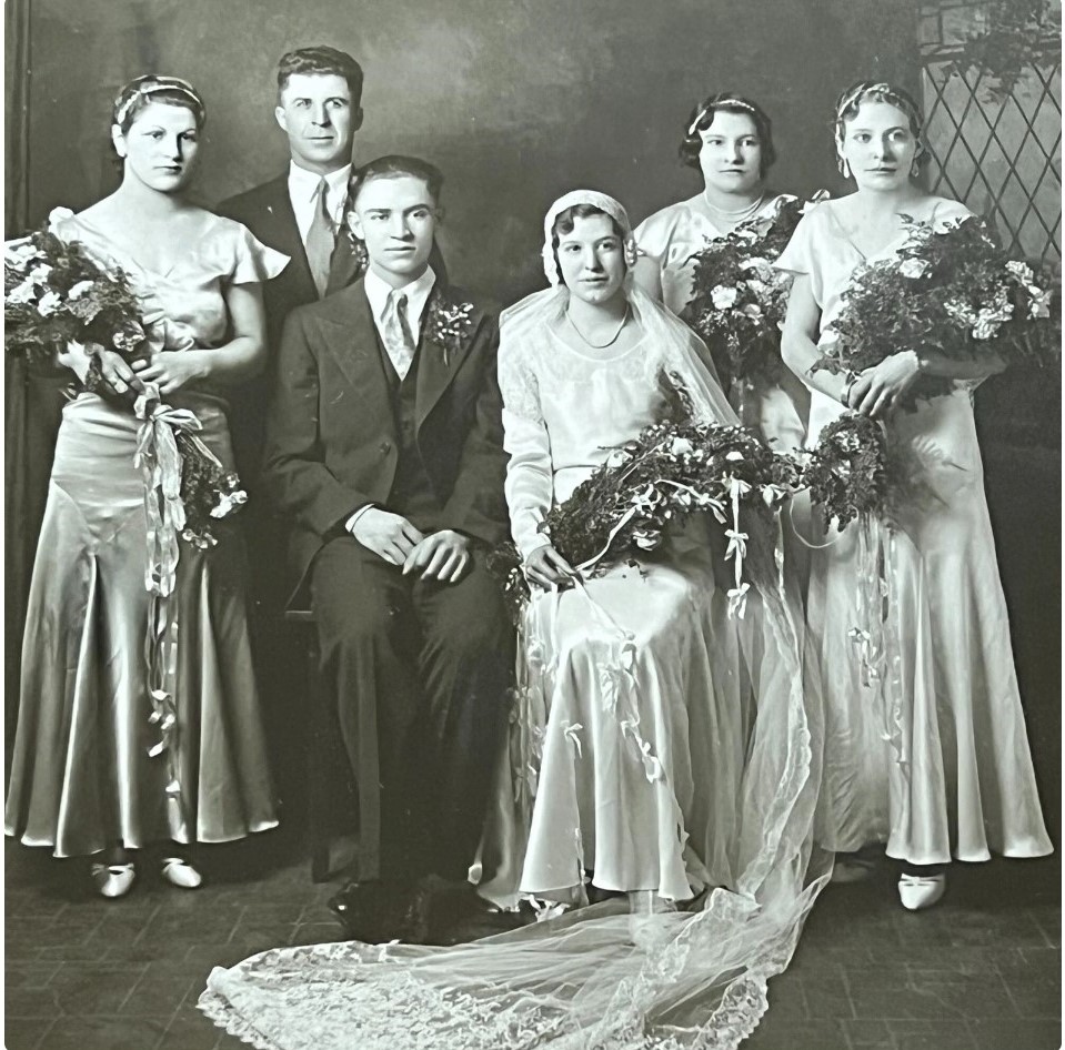 1930s vintage wedding photo of a 1930s wedding party featuring a 1930s bride and 1930s bridesmaid. 