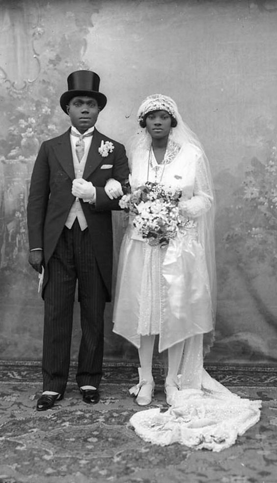 1920s Vintage Wedding Photo: Portrait of a Black bride and a groom on their wedding day. Photographed in 1927. Stunning 1920s Wedding Fashions 