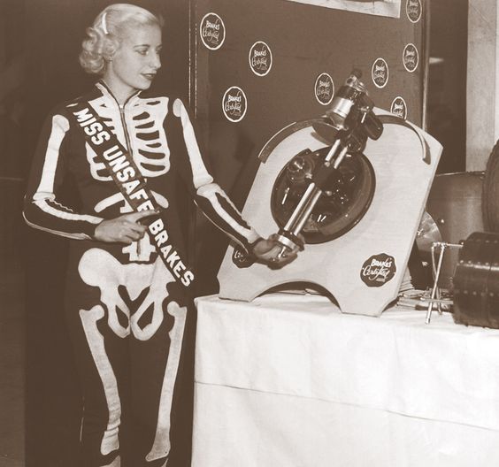 1930s Vintage Photo of Vintage beauty pageant winner, Miss Unsafe Brakes making an appearance at the 1939 Chicago Auto Show. She is wearing a skelton outfit. 