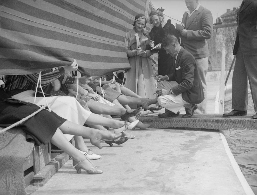 1930's vintage photo of women showing off their ankles for the prettiest ankle contest in England in 1933. Super 1930's shoes on display.