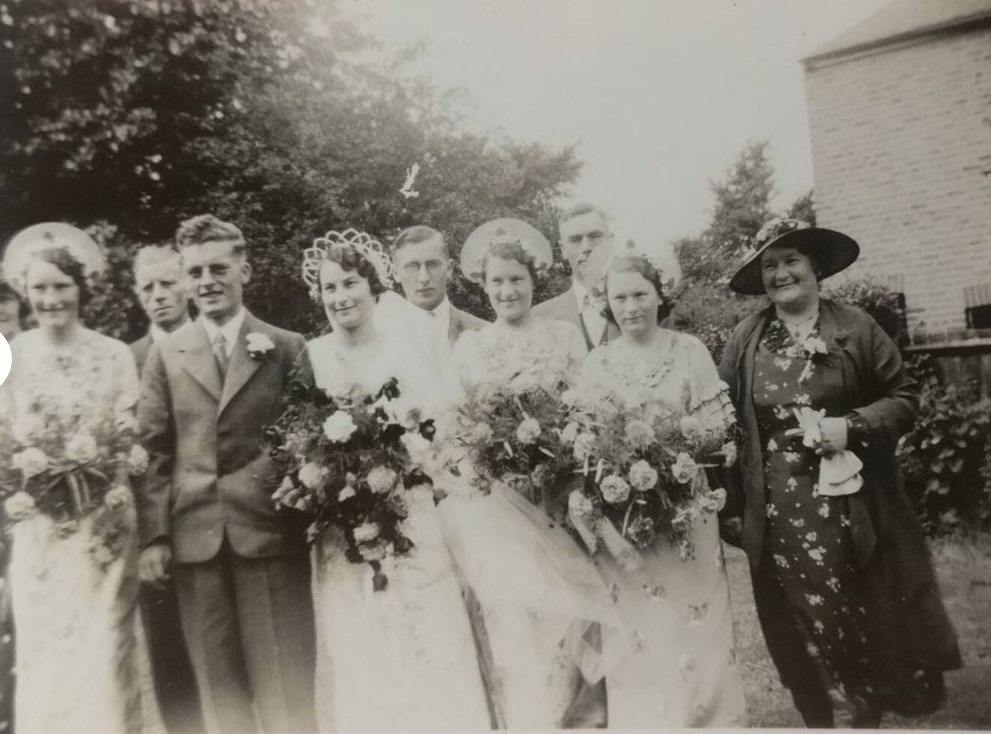 1930s vintage wedding photo of a 1930s bride and her 1930s bridesmaids and parents. Stunning 1930s wedding fashions. What a fantastic crown on our bride. 