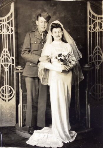 1940s vintage wedding photo of a young bride with a WW2 soldier in uniform on their wedding day