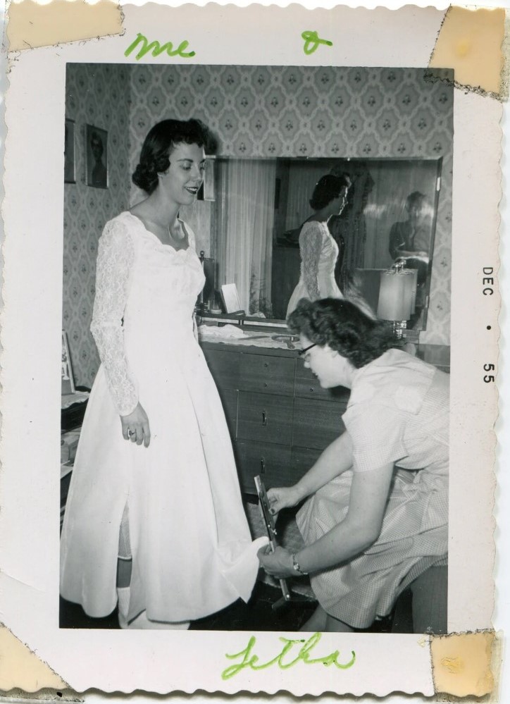 1950s Vintage Photo of a young woman in a 1950s wedding dress having it made in her bedroom - December 1955. 