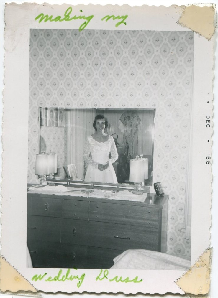 1950s Vintage Photo of a young woman in a 1950s wedding dress having it made in her bedroom - December 1955. 