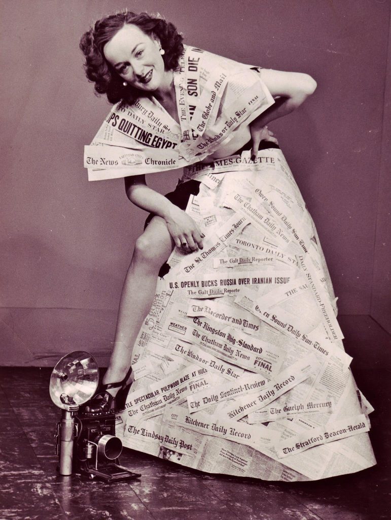 1940s Vintage Photo of Veronica Foster (Ronnie), The Bren Gun Girl as Miss By-Line 1943 in Toronto posing in Ontario Newspapers as a dress. 