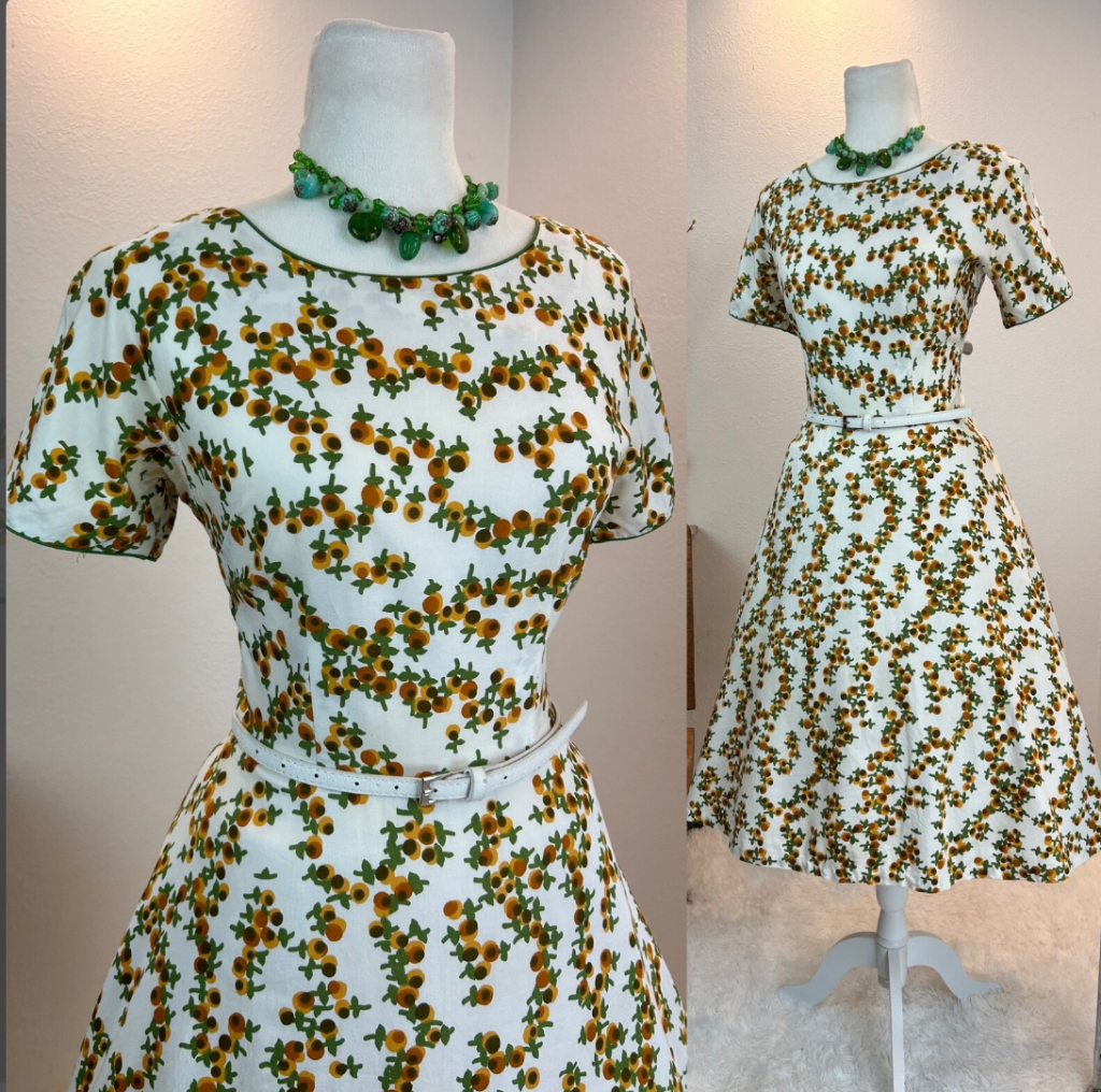 1950s Fashion: This 1950s dress has a gorgeous floral print and the perfect 1950s cut. She was made by the beloved dress makers at L’Aiglon. I love her print, the green piped trim in the neckline and cuffs and her full skirt. She has a metal zipper in the back.